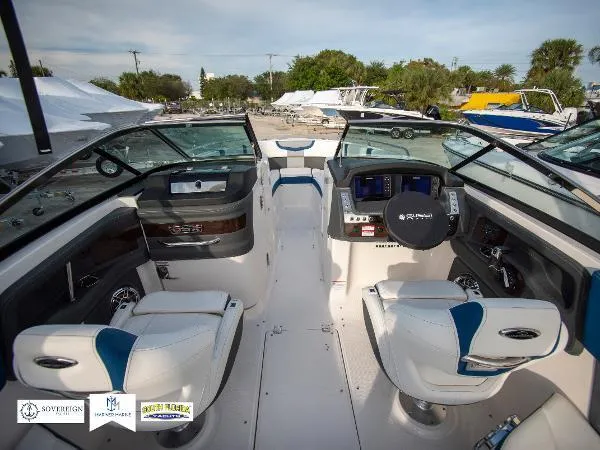Slide: The Image of 2024 Chaparral 270 OSX boat interior with modern dashboard and seating. - 24