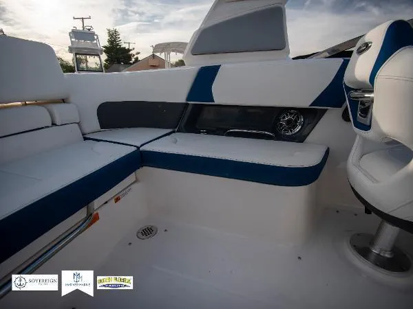 Slide: The Image of 2024 Chaparral 270 OSX boat interior with blue and white seating. - 26