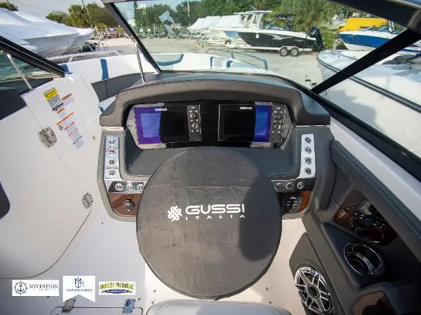 Slide: The Image of 2024 Chaparral 270 OSX boat dashboard with dual displays and Gussi Italia steering wheel. - 28
