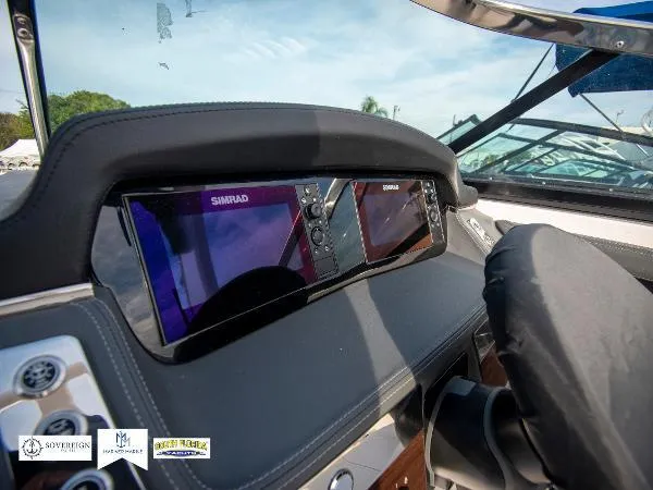 Slide: The Image of 2024 Chaparral 270 OSX dashboard with dual Simrad displays, showcasing modern navigation technology. - 29