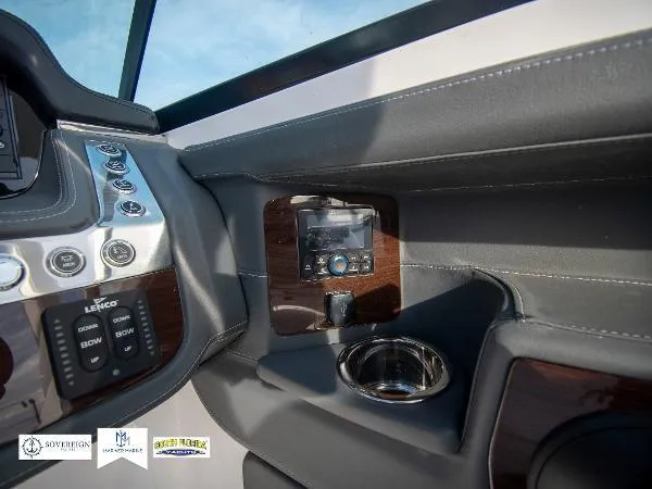 Slide: The Image of 2024 Chaparral 270 OSX dashboard with control panel and cup holder. - 31