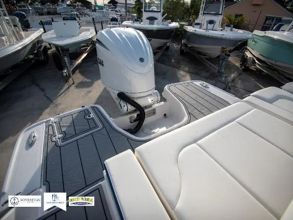 Slide: The Image of 2024 Chaparral 270 OSX boat with Yamaha outboard engine, docked in a marina. - 34