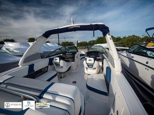 Slide: The Image of 2024 Chaparral 270 OSX boat interior with seating and dashboard, under a clear sky. - 36