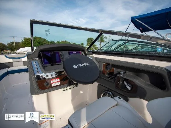 Slide: The Image of 2024 Chaparral 270 OSX boat dashboard with modern controls and steering wheel. - 37