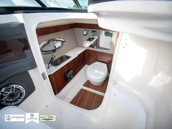 Slide: The Image of 2024 Chaparral 270 OSX boat interior with modern bathroom amenities and sleek design. - 39