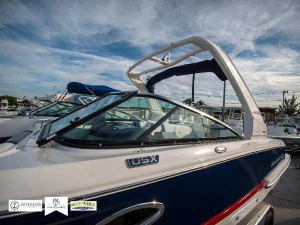 Slide: The Image of 2024 Chaparral 270 OSX boat with sleek design and modern features under a blue sky. - 5