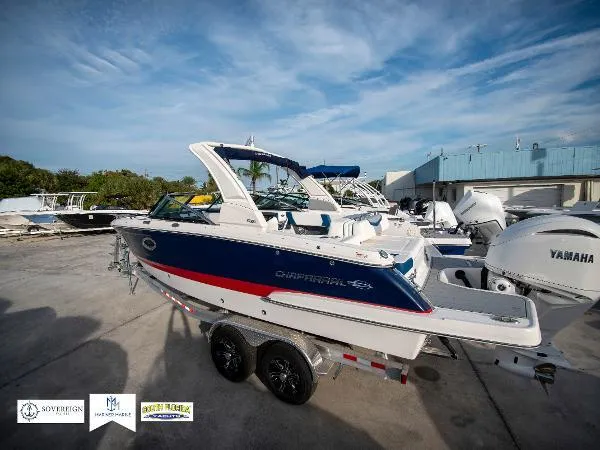Slide: The Image of 2024 Chaparral 270 OSX boat on trailer, featuring sleek design and Yamaha engines. - 9