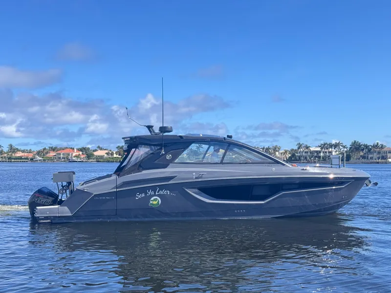 Slide: The Image of 2021 Cruisers Yachts 42 GLS OB on calm water under blue sky. - 1