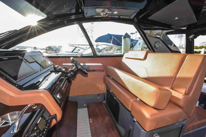 Slide: The Image of 2021 Cruisers Yachts 42 GLS OB interior with luxurious seating and modern dashboard. - 10