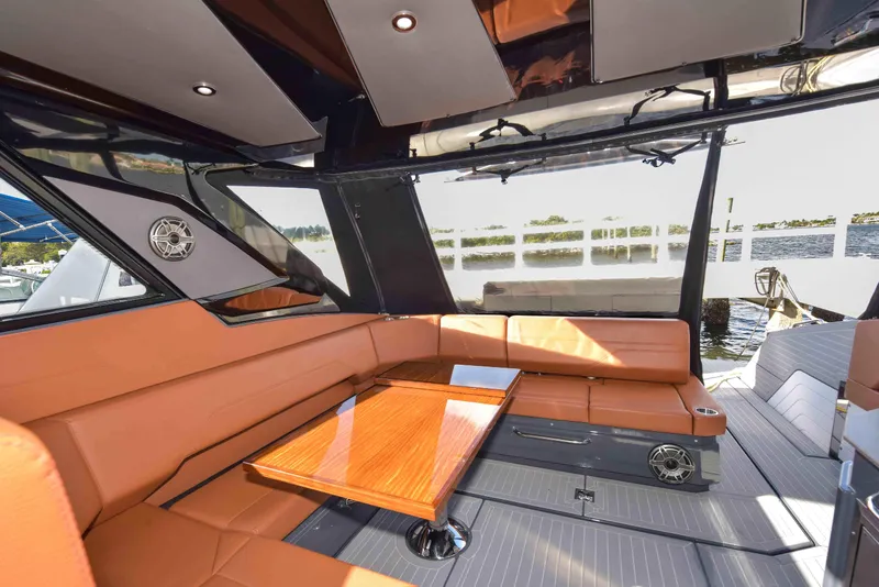 Slide: The Image of Luxurious interior of 2021 Cruisers Yachts 42 GLS OB with leather seating and wooden table. - 12