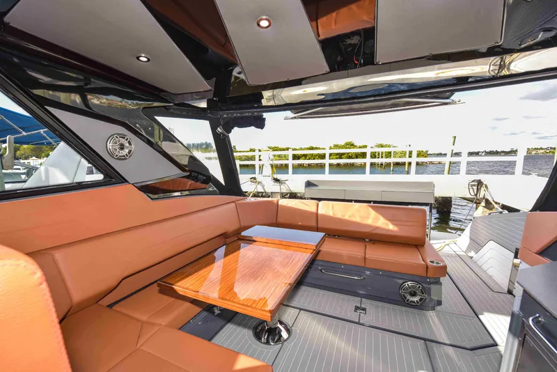 Slide: The Image of Luxurious interior of 2021 Cruisers Yachts 42 GLS OB with leather seating and wooden table. - 13