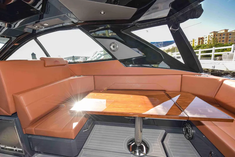 Slide: The Image of Luxurious interior of 2021 Cruisers Yachts 42 GLS OB with leather seating and wooden table. - 14