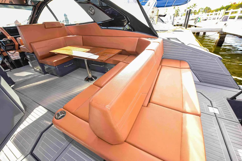 Slide: The Image of Luxurious 2021 Cruisers Yachts 42 GLS OB interior with elegant seating and table. - 15