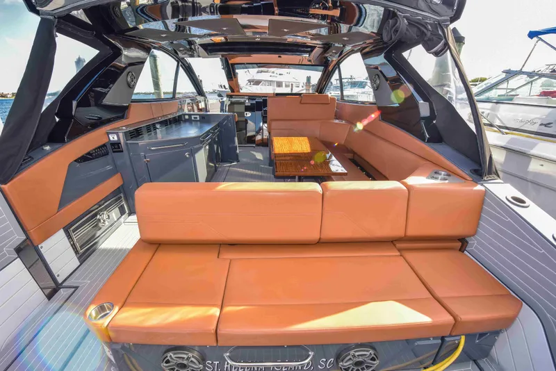Slide: The Image of 2021 Cruisers Yachts 42 GLS OB interior with orange seating and modern amenities. - 16