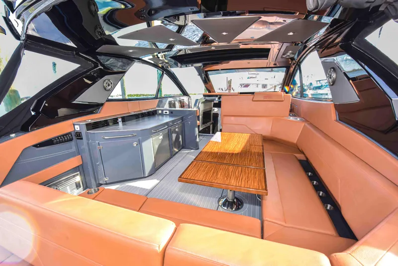 Slide: The Image of Luxurious interior of 2021 Cruisers Yachts 42 GLS OB with leather seating and wooden table. - 17