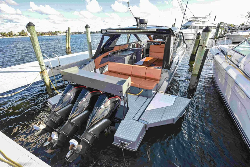 Slide: The Image of 2021 Cruisers Yachts 42 GLS OB docked, featuring triple outboard engines and spacious seating. - 23