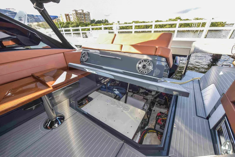 Slide: The Image of 2021 Cruisers Yachts 42 GLS OB with open engine compartment, docked by the water. - 31