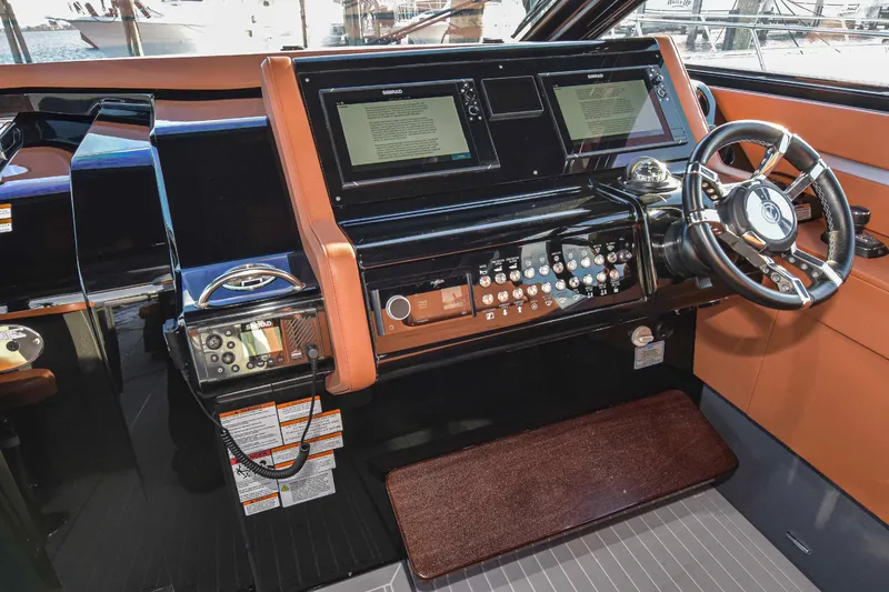 Slide: The Image of Helm of 2021 Cruisers Yachts 42 GLS OB with modern controls and dual displays. - 35