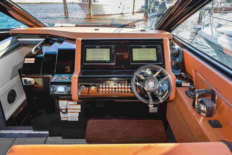 Slide: The Image of 2021 Cruisers Yachts 42 GLS OB helm with dual screens and modern controls. - 36