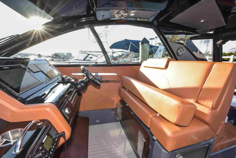 Slide: The Image of 2021 Cruisers Yachts 42 GLS OB interior with luxurious seating and modern dashboard. - 39