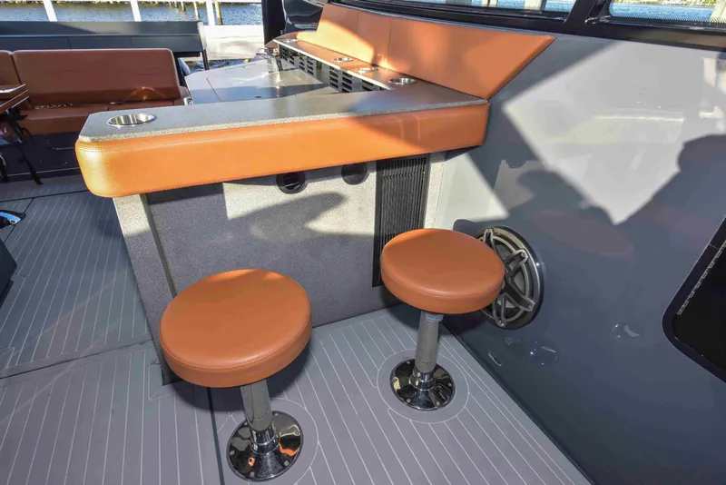 Slide: The Image of 2021 Cruisers Yachts 42 GLS OB interior with bar stools and counter. - 42