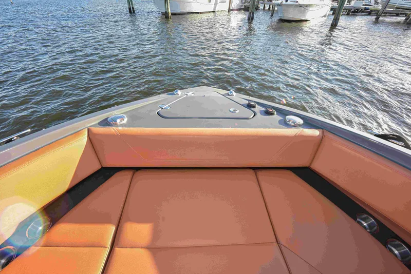Slide: The Image of 2021 Cruisers Yachts 42 GLS OB with orange seating, docked on calm water. - 43
