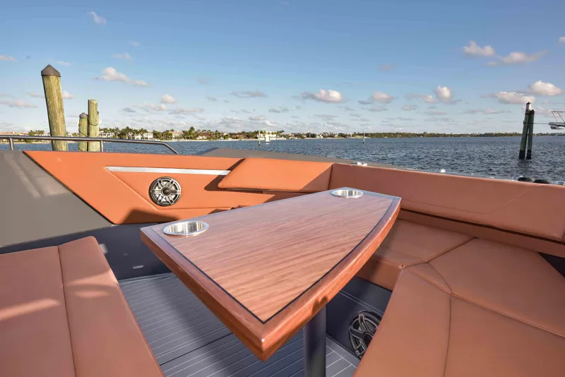 Slide: The Image of 2021 Cruisers Yachts 42 GLS OB interior with elegant seating and table, overlooking serene waters. - 44
