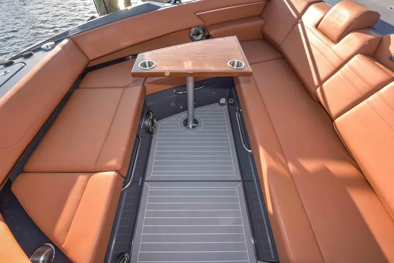 Slide: The Image of 2021 Cruisers Yachts 42 GLS OB interior with tan seating and a central table. - 46