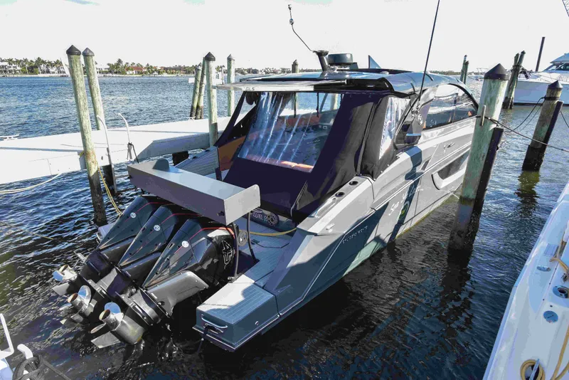Slide: The Image of 2021 Cruisers Yachts 42 GLS OB docked, featuring sleek design and powerful outboard engines. - 7