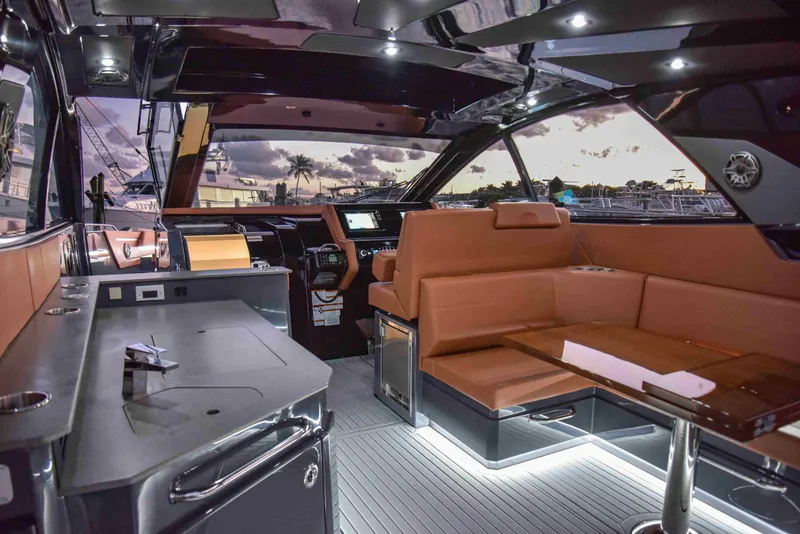 Slide: The Image of Luxurious interior of 2021 Cruisers Yachts 42 GLS OB at sunset, featuring elegant seating and modern design. - 8
