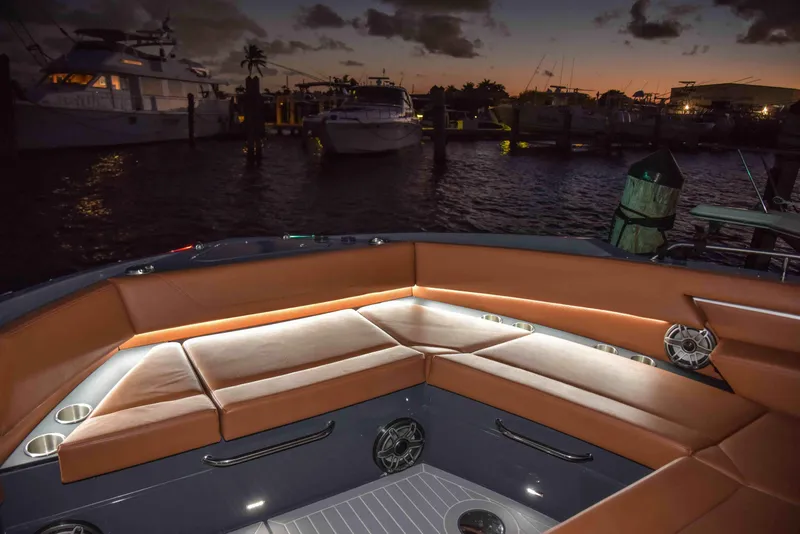Slide: The Image of Luxurious 2021 Cruisers Yachts 42 GLS OB with illuminated seating at sunset in marina. - 9