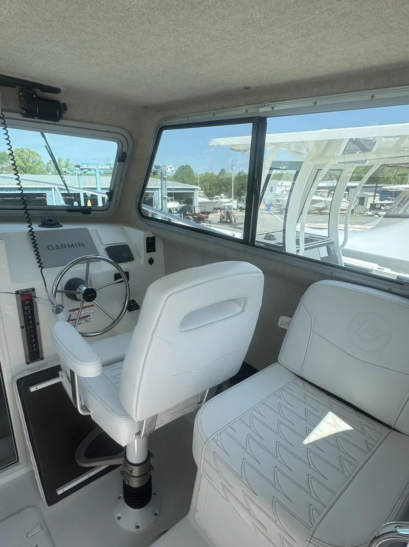 Slide: The Image of 2025 Parker 2520 XLD Sport Cabin interior with white seating and steering wheel. - 4