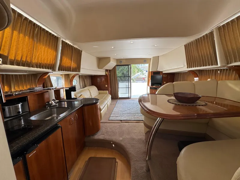 Slide: The Image of Luxurious interior of a 2004 Carver 420 Mariner yacht with kitchen and dining area. - 11