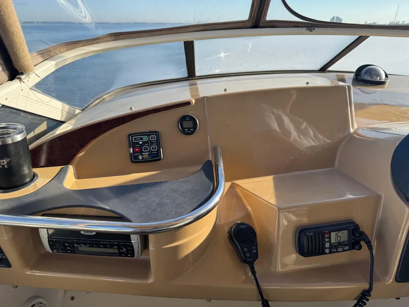 Slide: The Image of 2004 Carver 420 Mariner helm with controls, radio, and ocean view. - 19