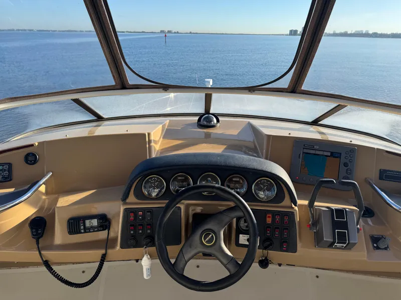Slide: The Image of Cockpit view of 2004 Carver 420 Mariner yacht with steering wheel and navigation instruments. - 14