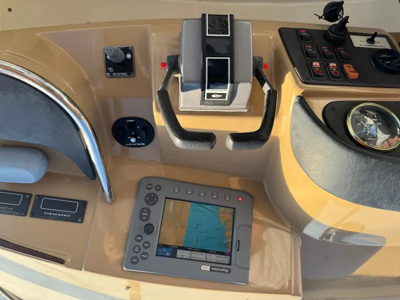 Slide: The Image of Control panel of a 2004 Carver 420 Mariner with navigation and throttle controls. - 15