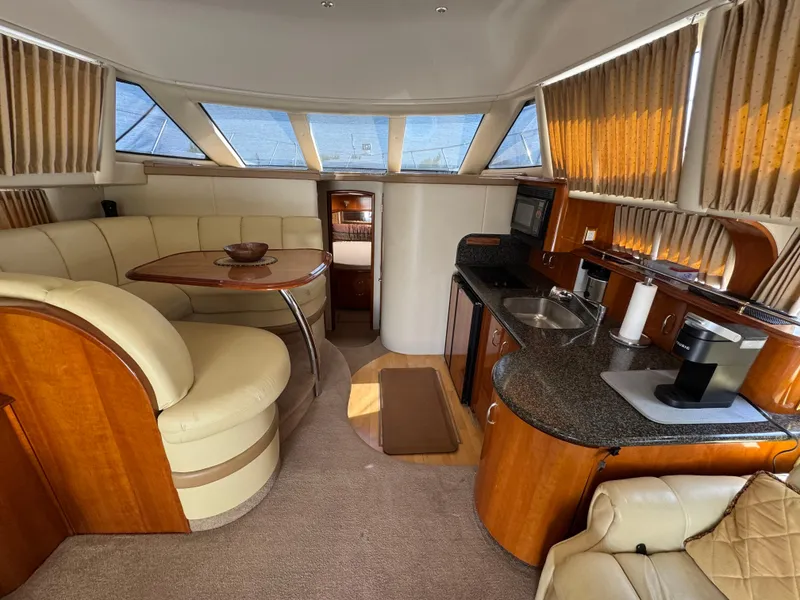 Slide: The Image of Luxurious interior of a 2004 Carver 420 Mariner yacht with kitchen and seating area. - 3