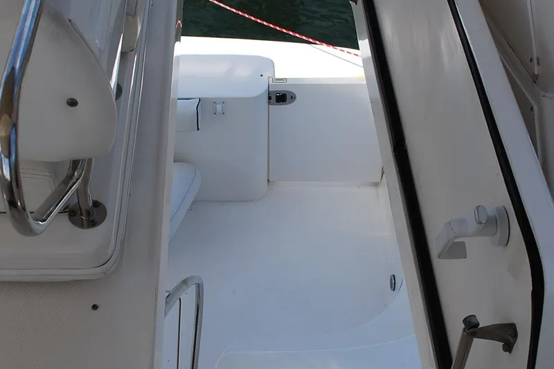 Slide: The Image of 2004 Sea Ray Sedan Bridge boat interior with white seating and railing. - 10