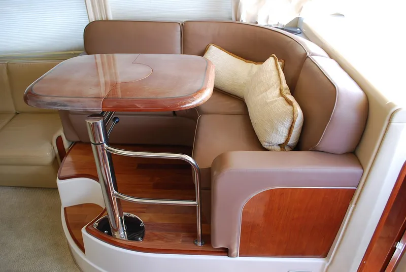Slide: The Image of Luxurious 2004 Sea Ray Sedan Bridge interior with elegant seating and wooden table. - 16
