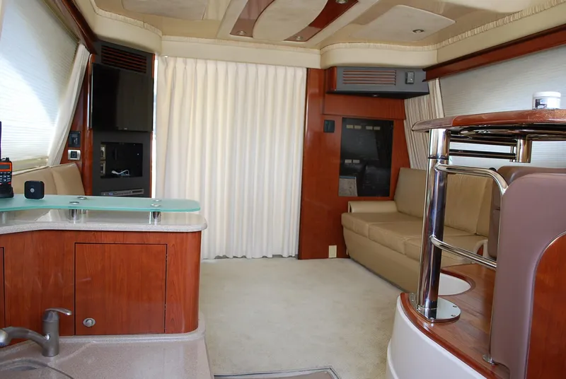 Slide: The Image of Luxurious interior of a 2004 Sea Ray Sedan Bridge yacht with elegant wood finishes. - 20