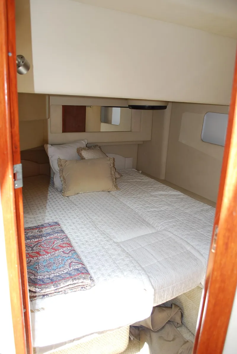Slide: The Image of 2004 Sea Ray Sedan Bridge cabin with cozy bed and elegant decor. - 24