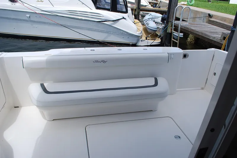 Slide: The Image of 2004 Sea Ray Sedan Bridge boat with white seating and docked at a marina. - 8