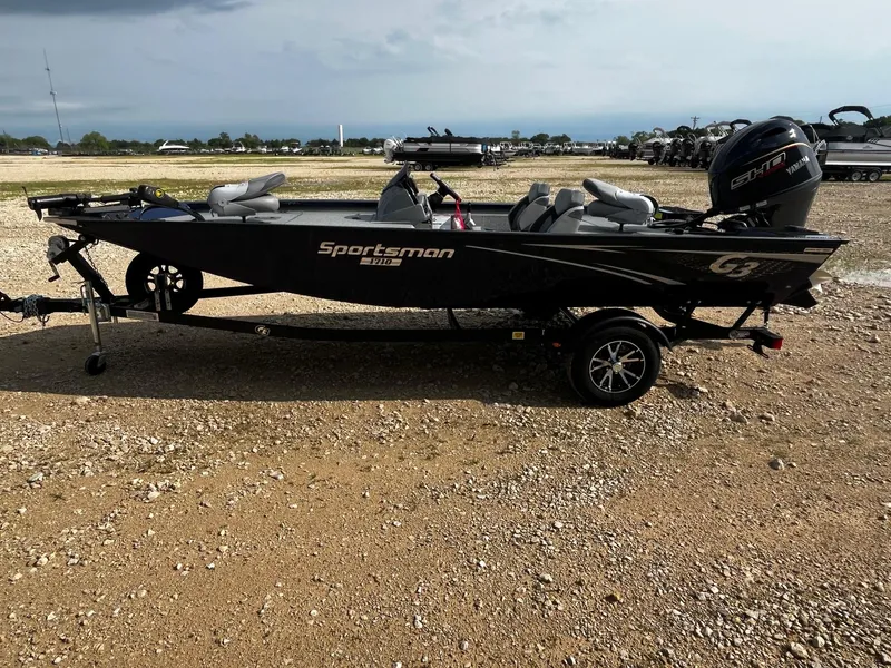 Slide: The Image of 2025 G3 Sportsman 1710 boat on trailer, parked on gravel lot under cloudy sky. - 4
