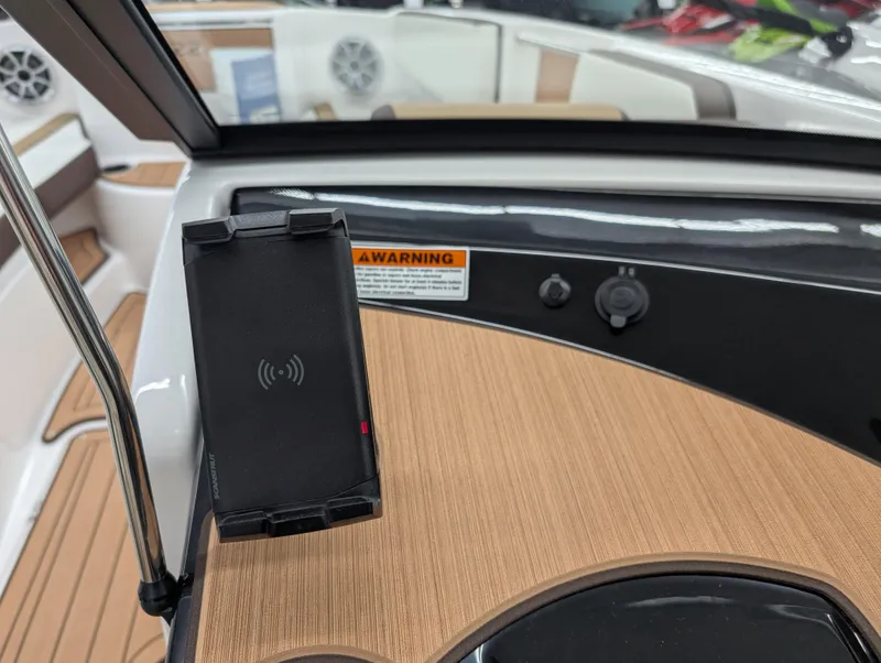 Slide: The Image of 2023 Yamaha Boats 222SD dashboard with phone holder and wood finish. - 8