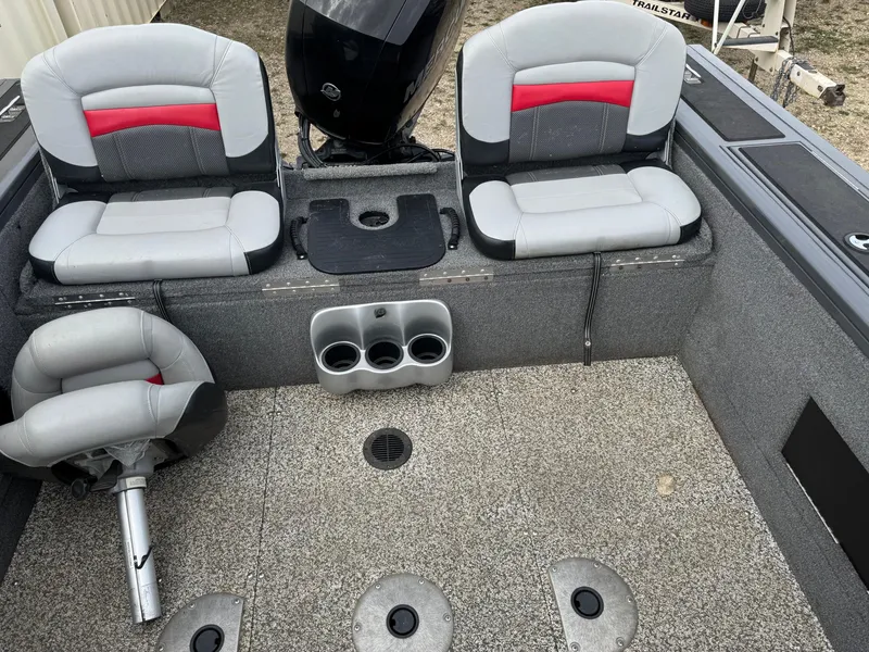 Slide: The Image of 2016 Tracker Targa V-18 Combo boat interior with seating and cup holders. - 9