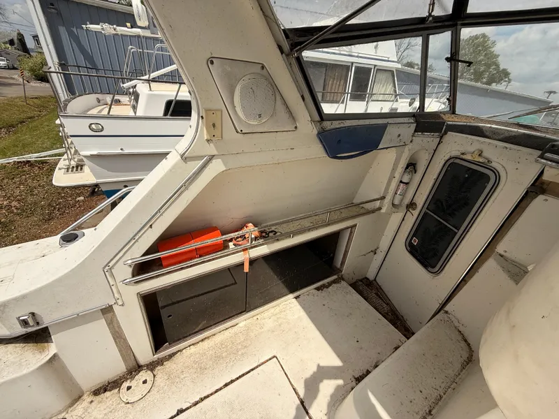 Slide: The Image of 1986 Cruisers 337 boat interior with life preserver and fire extinguisher, showing wear. - 10