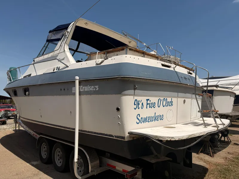 Slide: The Image of 1986 Cruisers 337 boat on trailer, "It's Five O'Clock Somewhere" text on stern. - 2