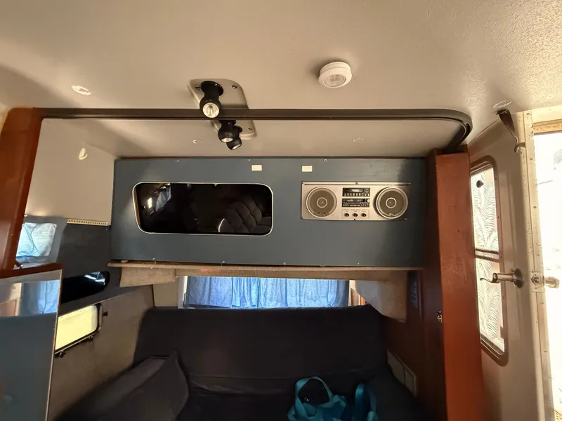 Slide: The Image of Interior of a 1986 Cruisers 337 boat with vintage stereo system and seating area. - 21