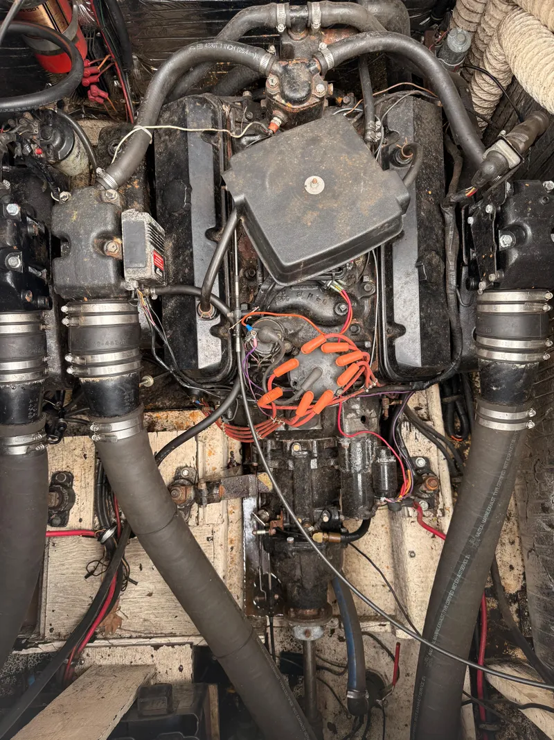 Slide: The Image of Engine compartment of a 1986 Cruisers 337 boat, showing hoses and wiring. - 25