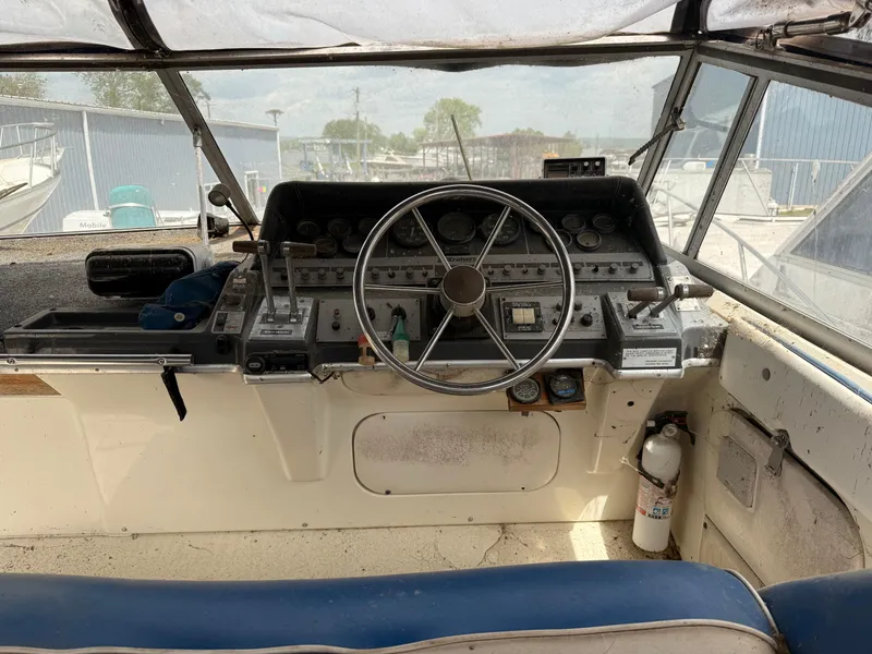 Slide: The Image of 1986 Cruisers 337 boat cockpit with steering wheel and control panel. - 4